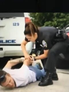 Policewoman arresting handcuffing girl.