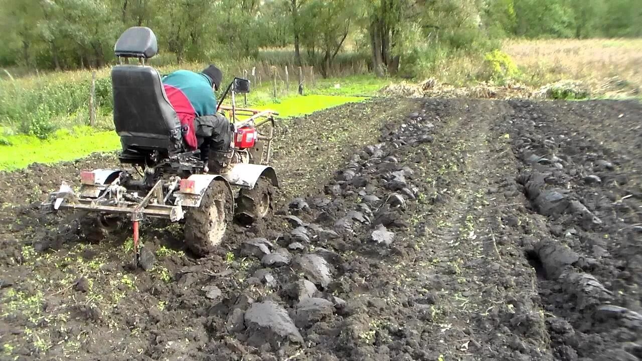 Как правильно мотоблоком с фрезами видео. Вспашка земли мотоблоком с адаптером. Минитрактор фермер т 12 с плугом. Минитрактора пахота 4на4. Пахота плугом минитрактор.