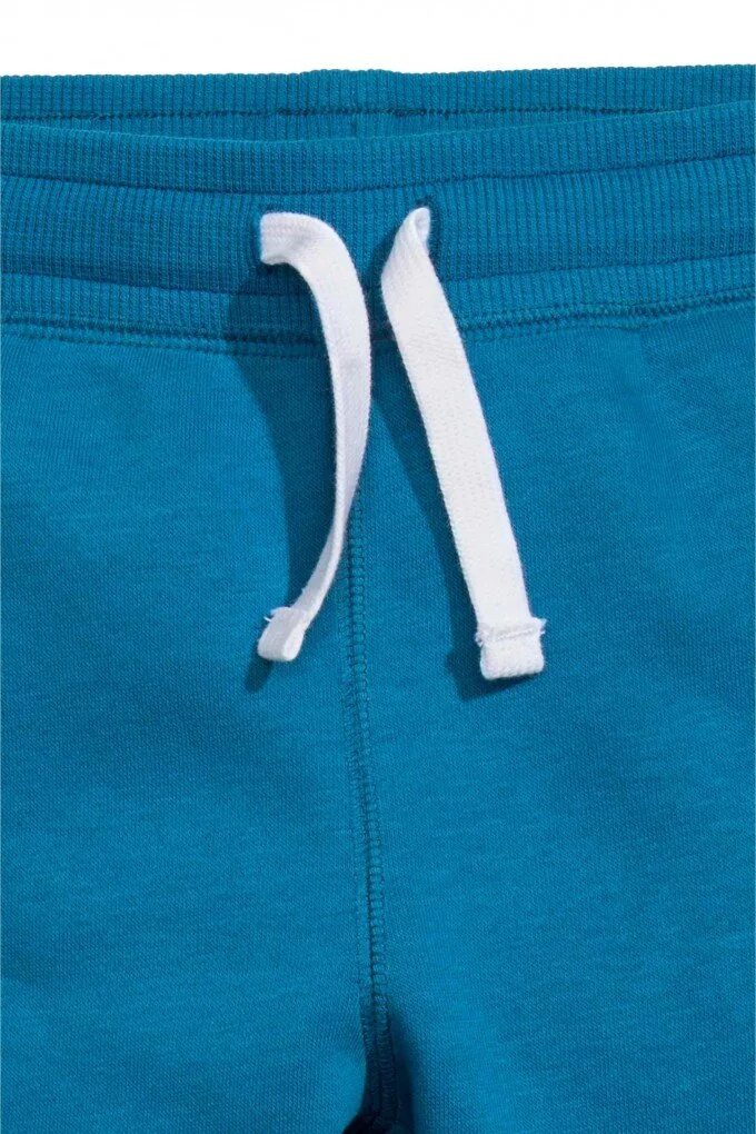 Пошив спортивных штанов. Пояс на спортивных штанах. Пояс на спортивных штанах. Reebok 10140320 спортивные штаны флис. Шнурок в поясе спортивных штанов.