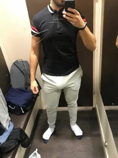 a man is taking a selfie in the mirror while wearing white pants and socks 