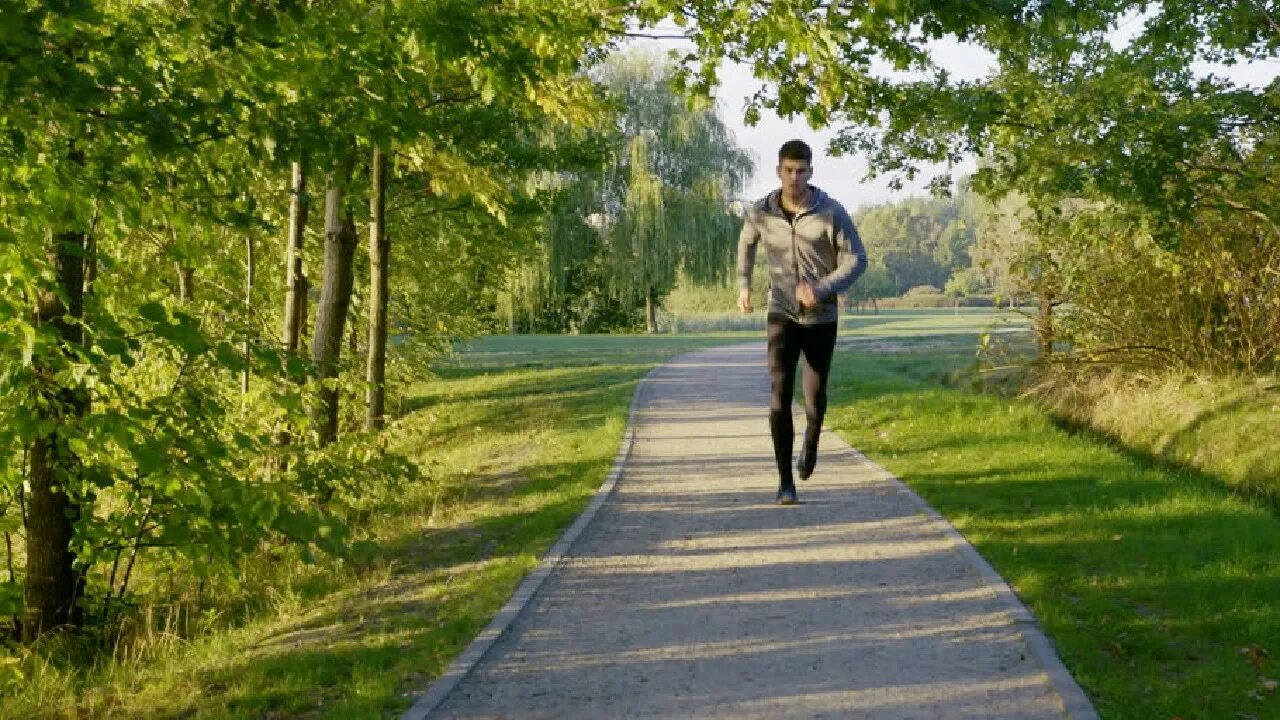 He walks in the park. Длинная прогулка. Длительные прогулки. Run man. Young man Running in Park.