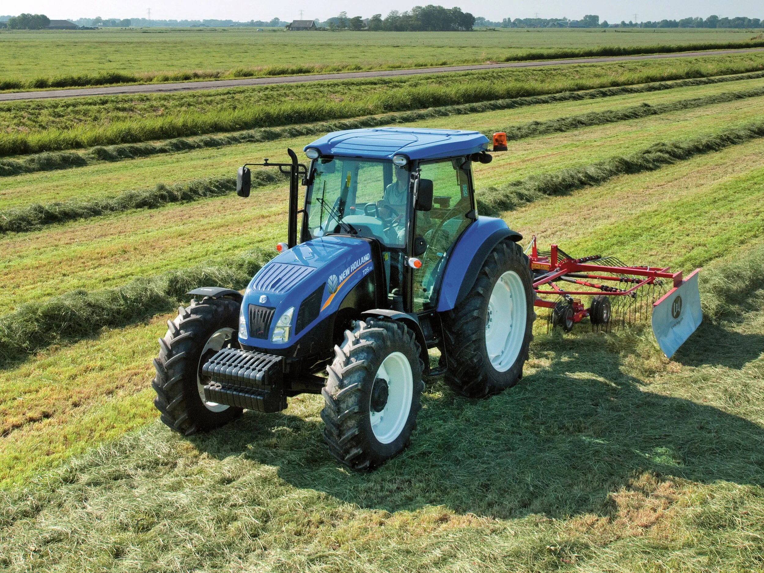 Тракторный бюджет. New Holland td 5,85. New Holland td5. New Holland td5.110. Трактор Нью Холланд в поле.