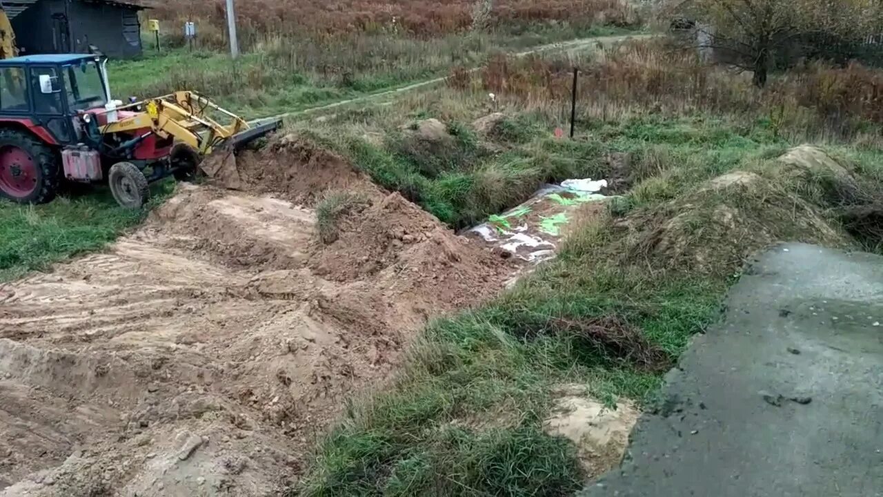 Земляная засыпка. Трактор для разравнивания участка. Выравнивание участка трактором. Разравнивание и планировка грунта. Отсыпка оврага.