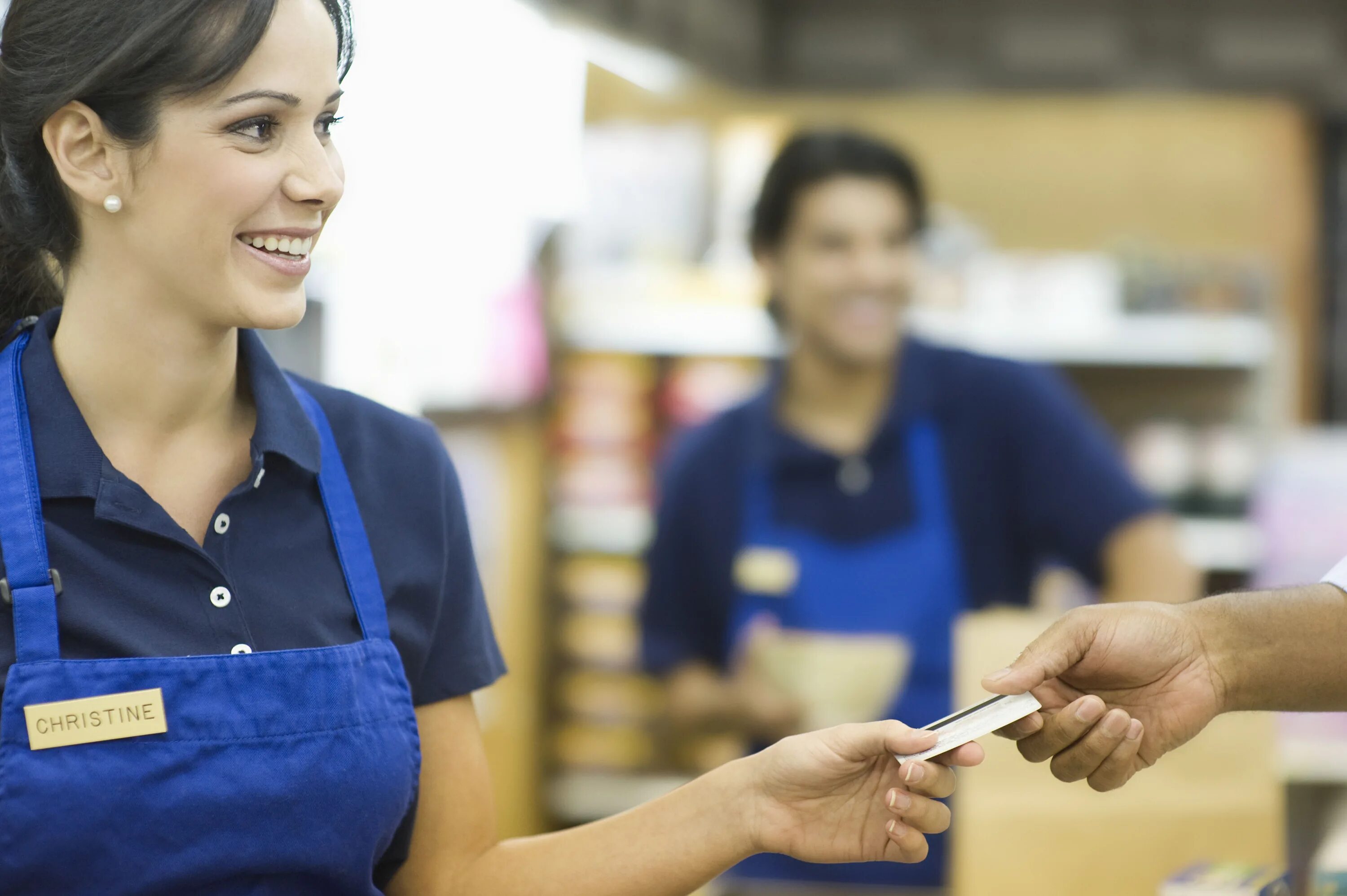 She is a shop assistant. Девушка продавец. Продавец кассир. Сотрудники магазина. Продавец в магазине.