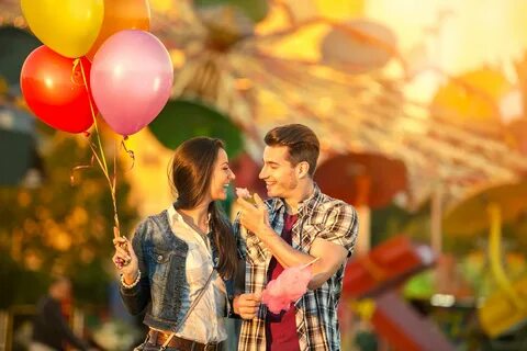 Happy couple in amusement park.