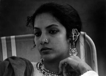 an old photo of a woman wearing jewelry.