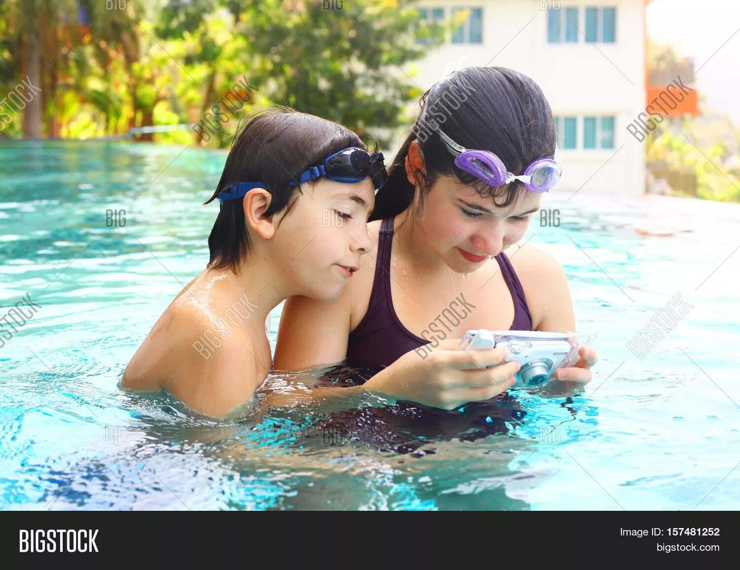 Sisters and brother swimming. Girl with brother in Pool.