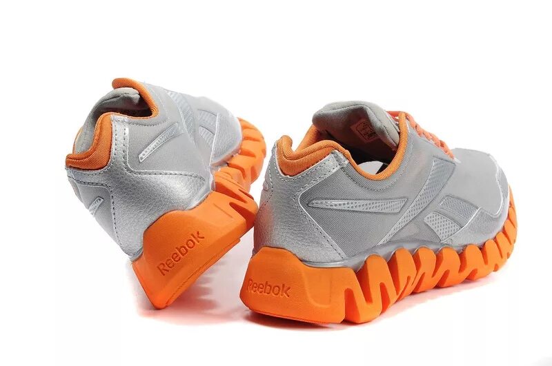 Озон рибок мужские. Оранжевые кроссовки Reebok 7735. Reebok zigtech Orange Grey. Кроссовки Reebok оранжевые мужские. Reebok bb4000 с оранжевой подошвой.