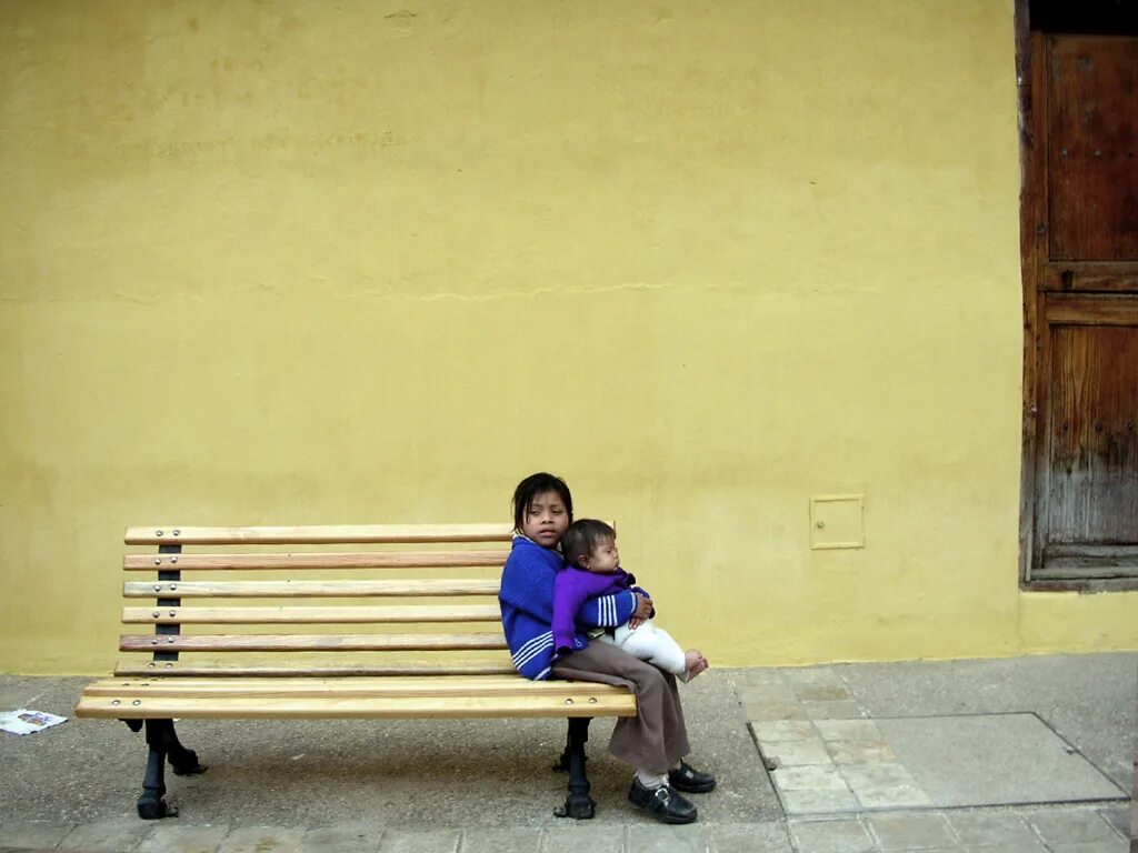 Children sitting on the Street. Children sitting on a Bench in the Park. The child sat on the Bed. Homeless children is crying without a parents. Sit on a bench