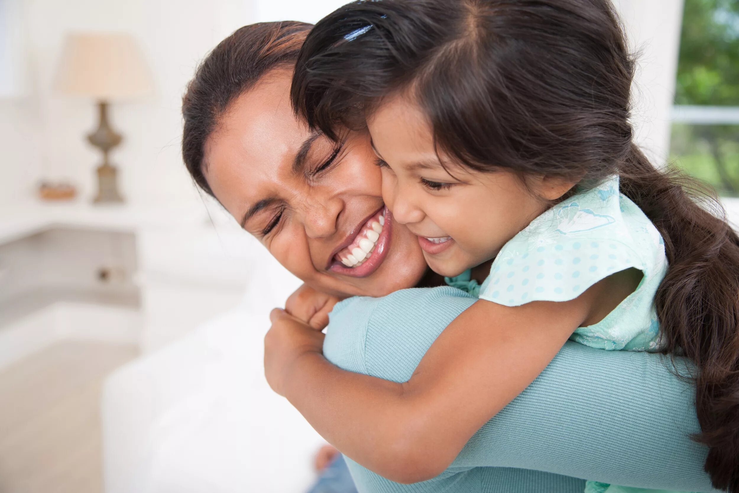 Mother has a daughter. Mother hugging. Mum and Happy child.