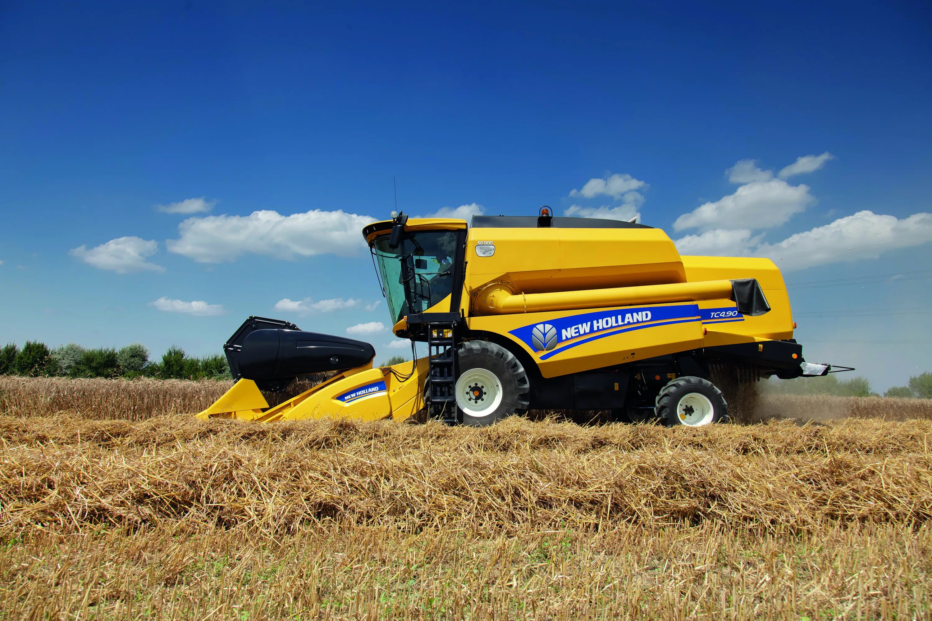 Каталог new holland. Комбайн Нью Холланд. New Holland tc4 90. Комбайн New Holland TC4.90. Зерноуборочный комбайн ниухоланд.