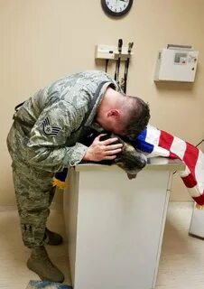 Solider Kyle Smith crying over the body of his beloved dog, Bodza, who once...