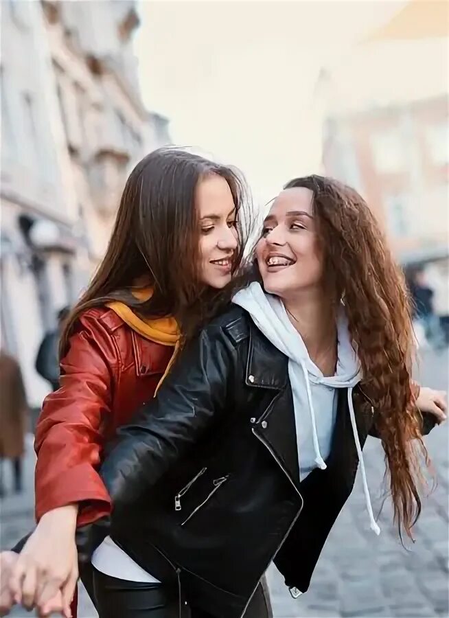 Smiling lesbian couple embracing and looking. Lesbian having fun