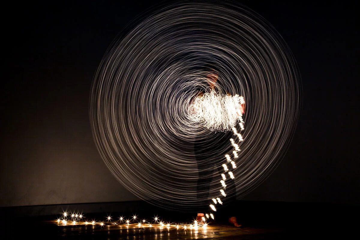 девушка в темноте со вспышкой. приложение со светом. танец свет. кадр с большой выдержкой. приложение со светом.