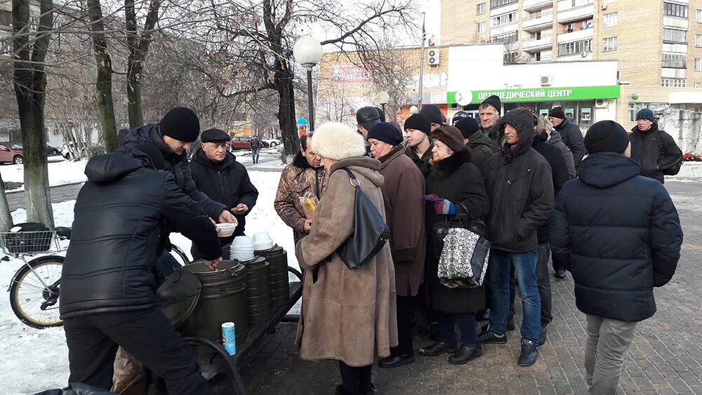 волонтеры и бездомные. малоимущие бомжи. раздача еды. благотворительность бездомным. раздача еды бездомным россия.