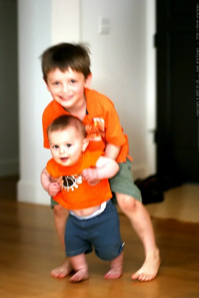 Teaching brother. Brother teaching to walk. helping to walk. sister helping walk. brother helping walk.