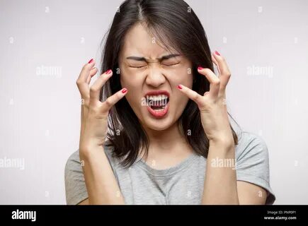 Frustrated Angry Asian woman isolated over white background. 