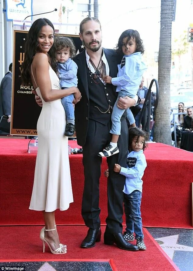 Zoe Saldana is every bit the doting mom as she grins from ear-to-ear while out w