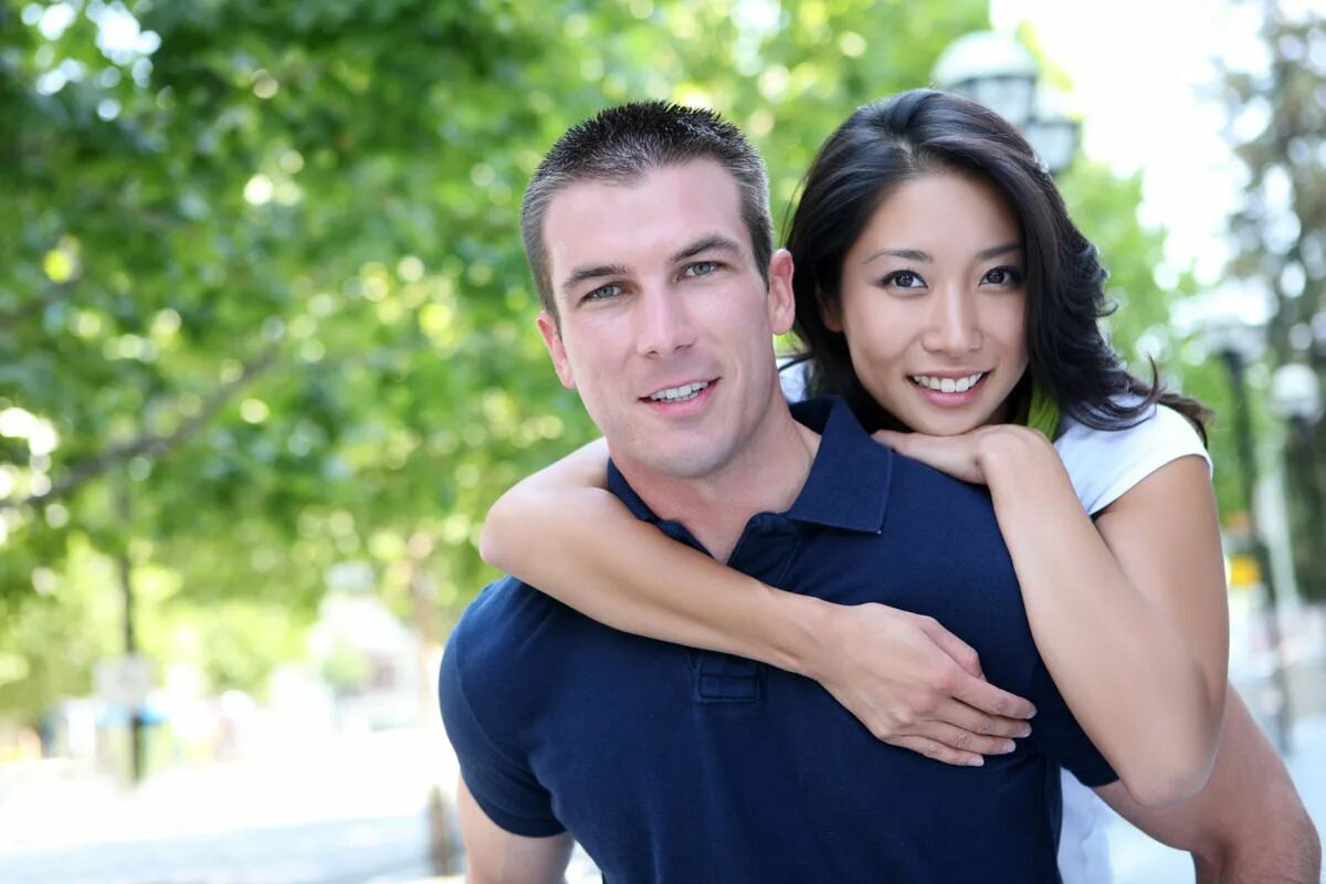 Европеец и азиатка. Счастливые пары. Счастливые мужчина и женщина. Молодые пары.