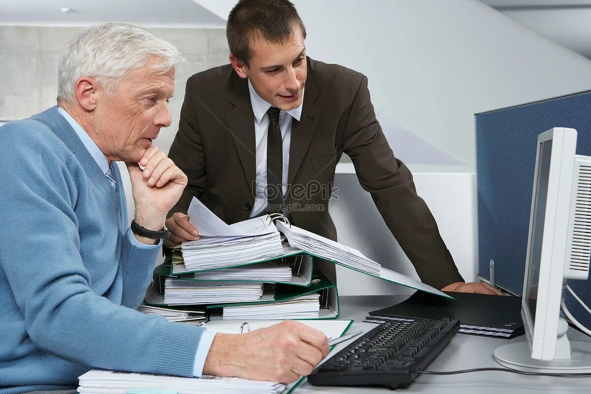 Пожилой бизнесмен. Пенсионер в офисе. Пожилой человек в офисе. Опытный работник. Младший приветствует старшего