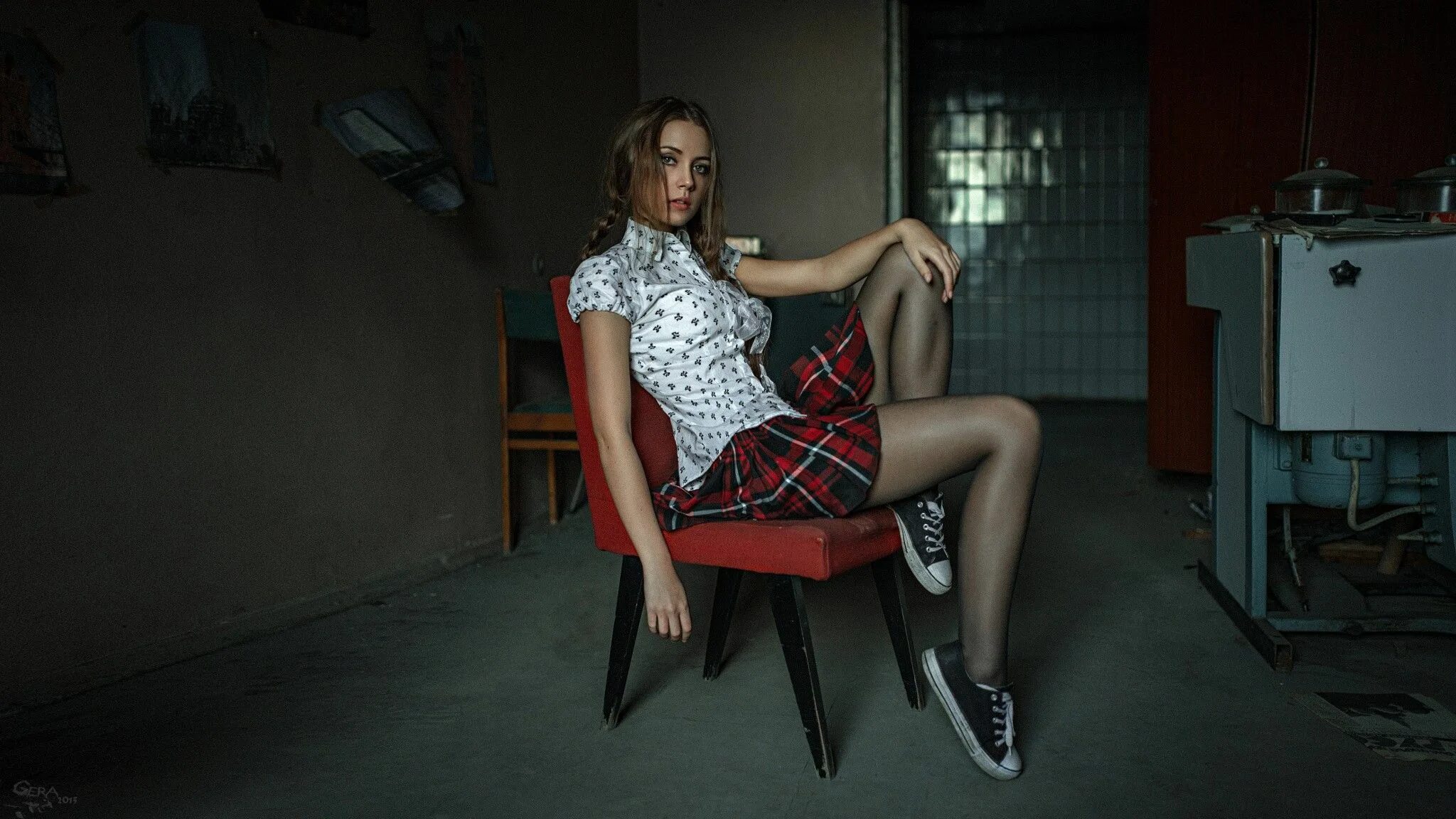 Woman sitting on desk. Full body of a young brunette business woman sitting on o