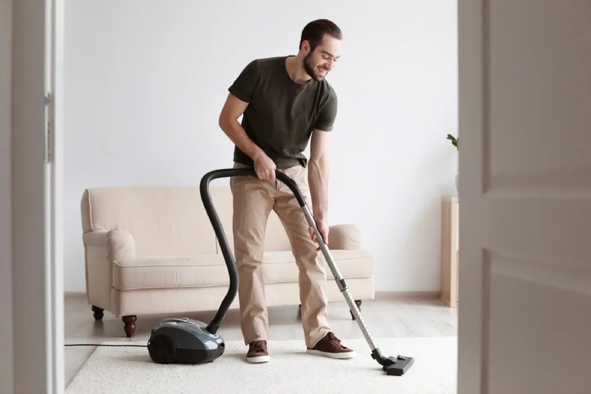 Home vacuum cleaner. Человек пылесосит. Человек убирается. Мужчина с пылесосом. Человек пылесос.