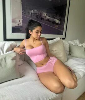Seductive Elegance: Noelle Emily Shines in a Tight Pink Outfit.