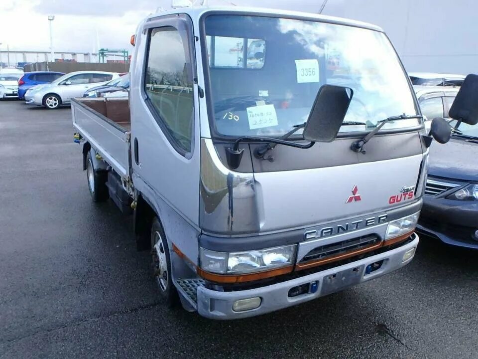 Продажа грузовиков чита. Mitsubishi Canter 1999 синий самосвал 3 тонны вид спереди. Митсубиси Кантер фото 1996. Мицубиси Кантер купить без документов. Дром Владивосток продажа Митсубиси Кантер 4 /4.