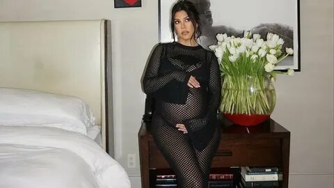 Kourtney Kardashian displays her bump in sexy mesh dress.