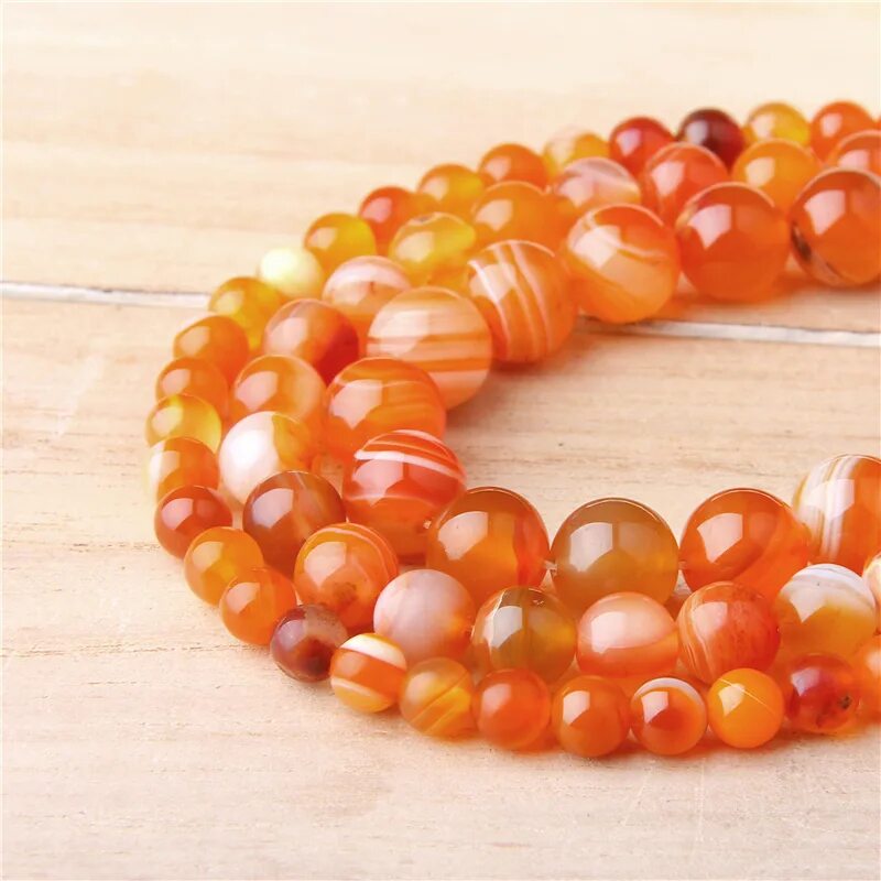 оранжевые бусины. оранжевый натуральный камень. камень оранжевого цвета. оранжевый непрозрачный камень. оранжевые крупные бусы.