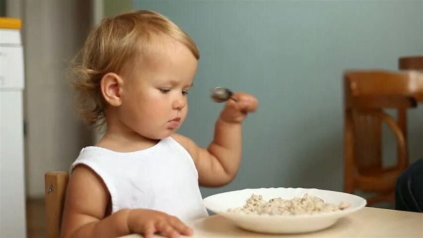 Человек есть гречку. Ребенок ест кашу. Ребенок завтракает кашей. Ребенок ест гречневую кашу. Каша для детей в детском саду.