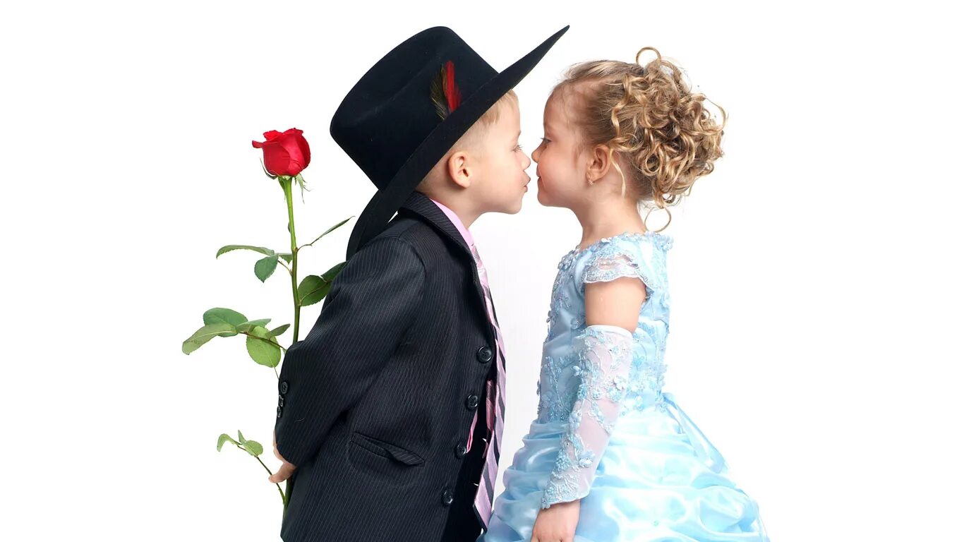 Мальчик дарит девочке цветы. Любовь к ребенку. Мальчик и девочка с цветами. Мальчик целует девочку.