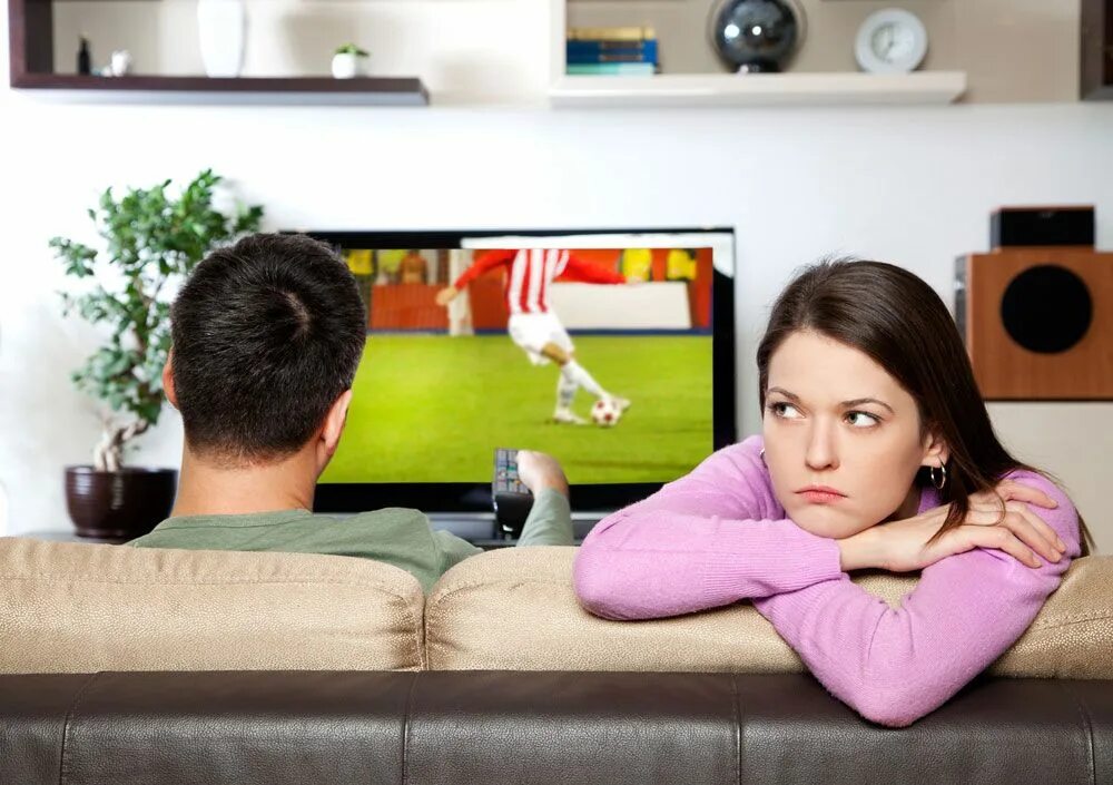 She don t watch tv. Мужчина у телевизора. Мужчина и женщина на диване. Муж с женой у телевизора. Женщина у телевизора.
