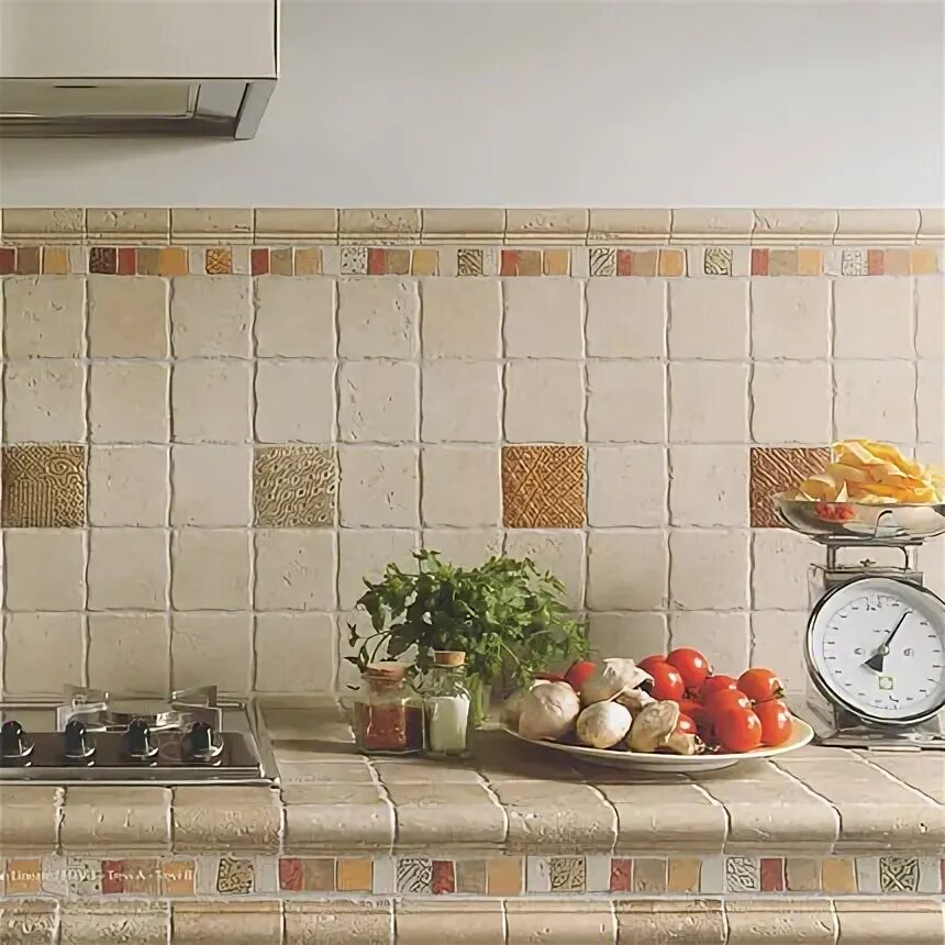 A white island is fitted with a KitchenAid dishwasher and a farmhouse sink with 