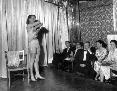 1958: Amateur stripper performing a striptease act. 