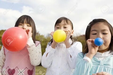 Japanese Girls Blowing Up A Balloon Stock Photo, Picture And Royalty Free.....