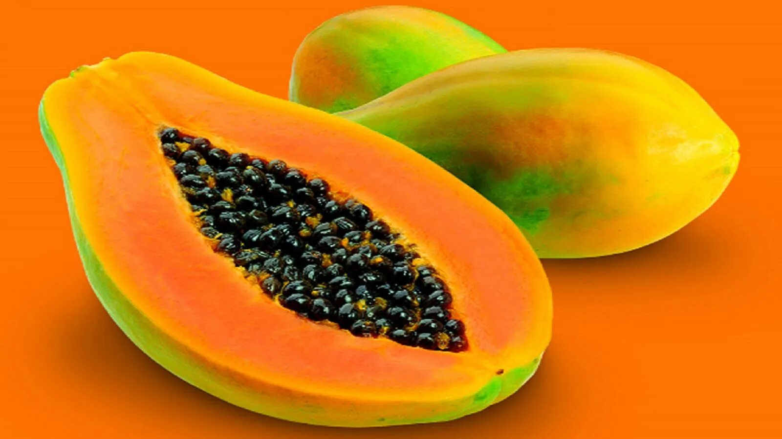 Оранжевый фрукт с черными. Папайя фрукт. Папайя Вашингтон. Оранжевый цвет папайя. Незрелая папайя.