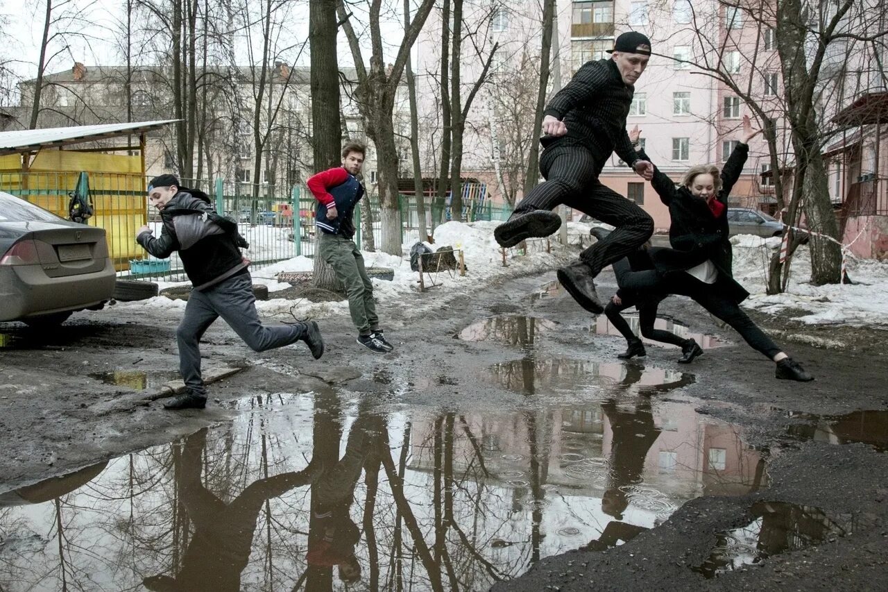 Лужа терпеть. Прыгать через лужи. прыжок через лужу. лужа в городе. перепрыгивает через лужу.