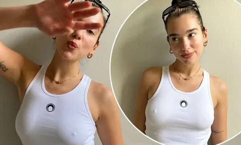 Dua Lipa poses braless in a tight white tank top after revealing she's...