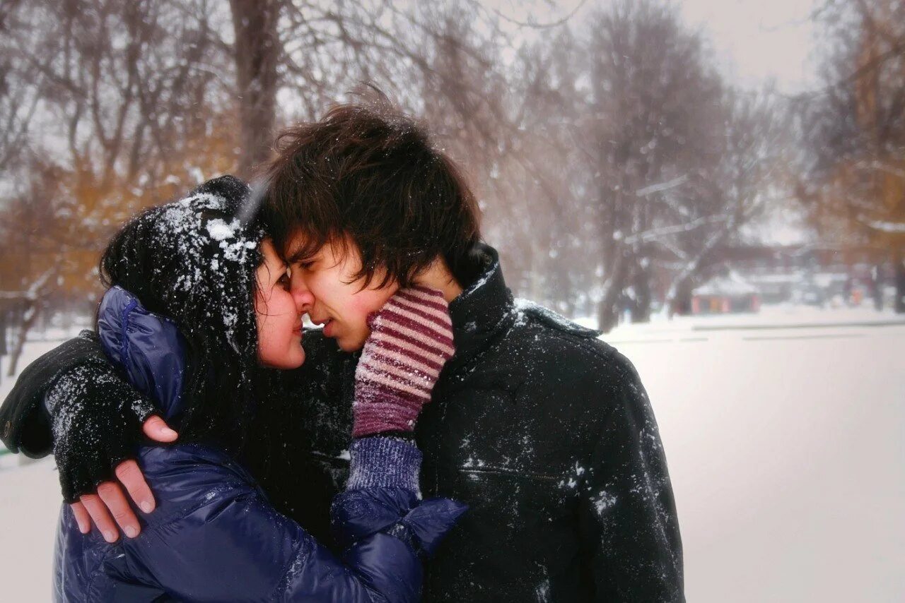Парень целуется на улице. Зимний поцелуй. Зимние объятия. Парень обнимает девушку зимой. Влюбленные в снегу.