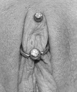 Few women wear a straight bar with a deep clitoral hood piercing, but occas...