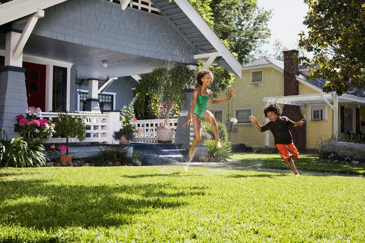 Standing in the yard dressed like a. Children playing in the yard. in the yard. children playing in the house.