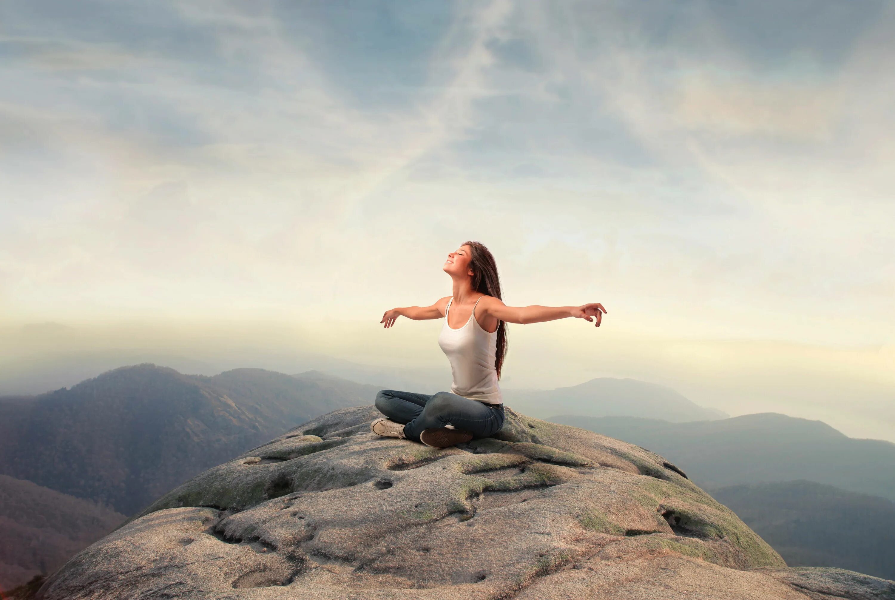 Девушка медитирует на вершине горы. Девушка на вершине горы. Девушка медитирует в горах. Медитация в горах.