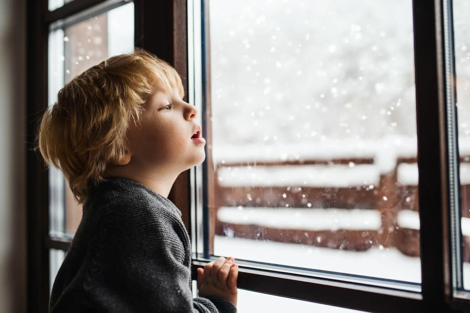 Look out of the window it snow. Kid looking out the window &quot;night&quot;. kid looking to window of richman.