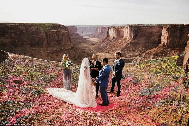 Daredevil newlyweds pose for wedding snaps while dangling 330ft up a cliff face 