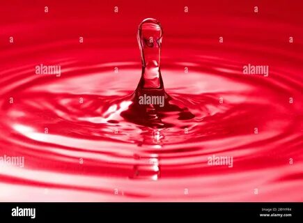 droplet splash in a red water Stock Photo. 