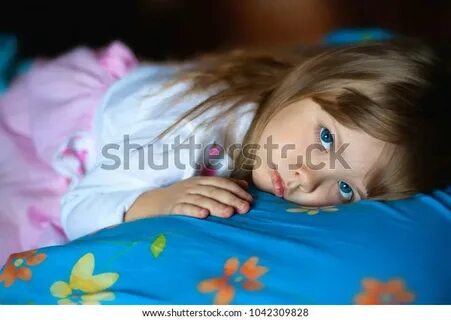 Portrait of cute little girl lay on bed. twitter. linkedin. facebook. 