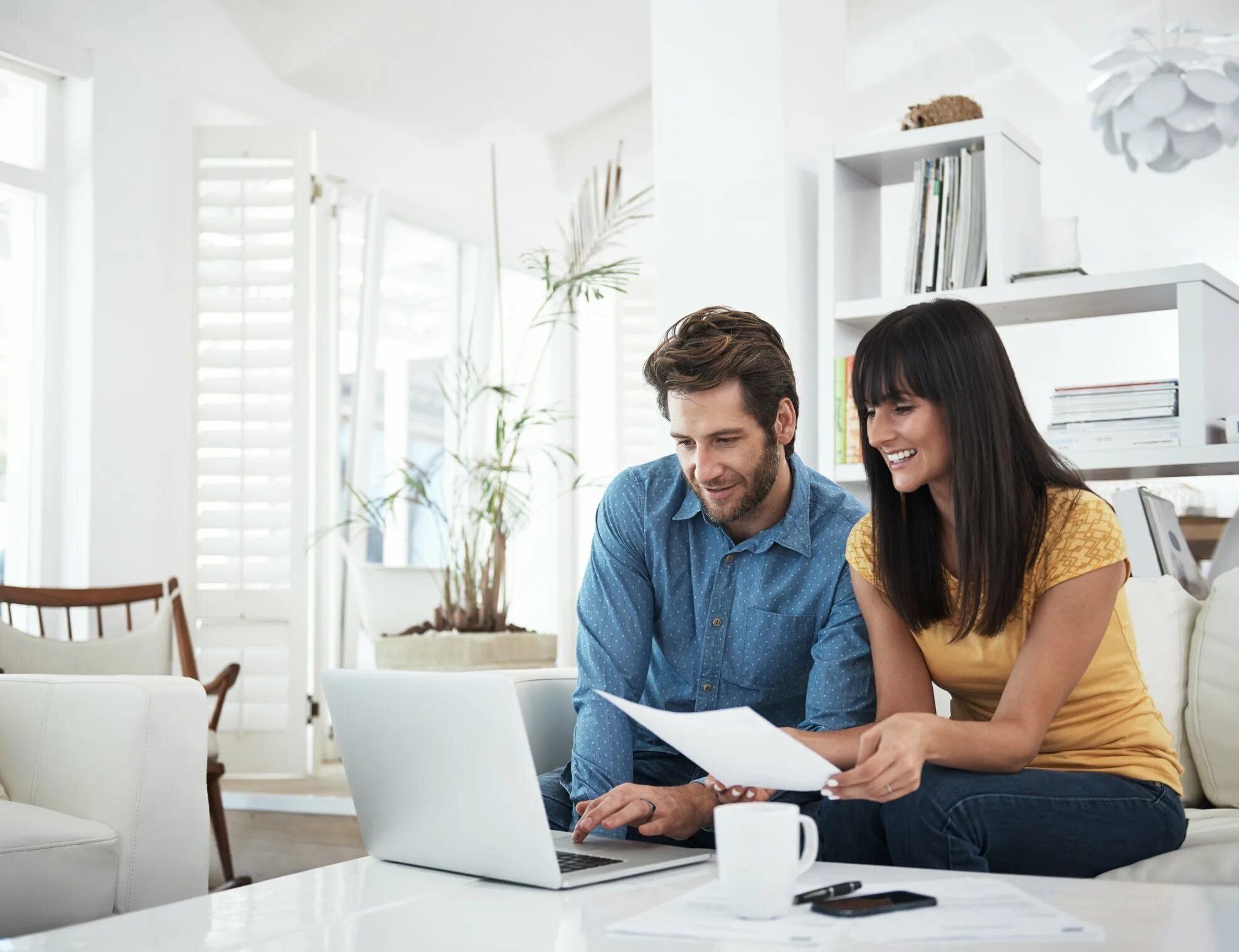 Two people on the Computer. Personal small loans. 4 Peoples looking at Laptop.