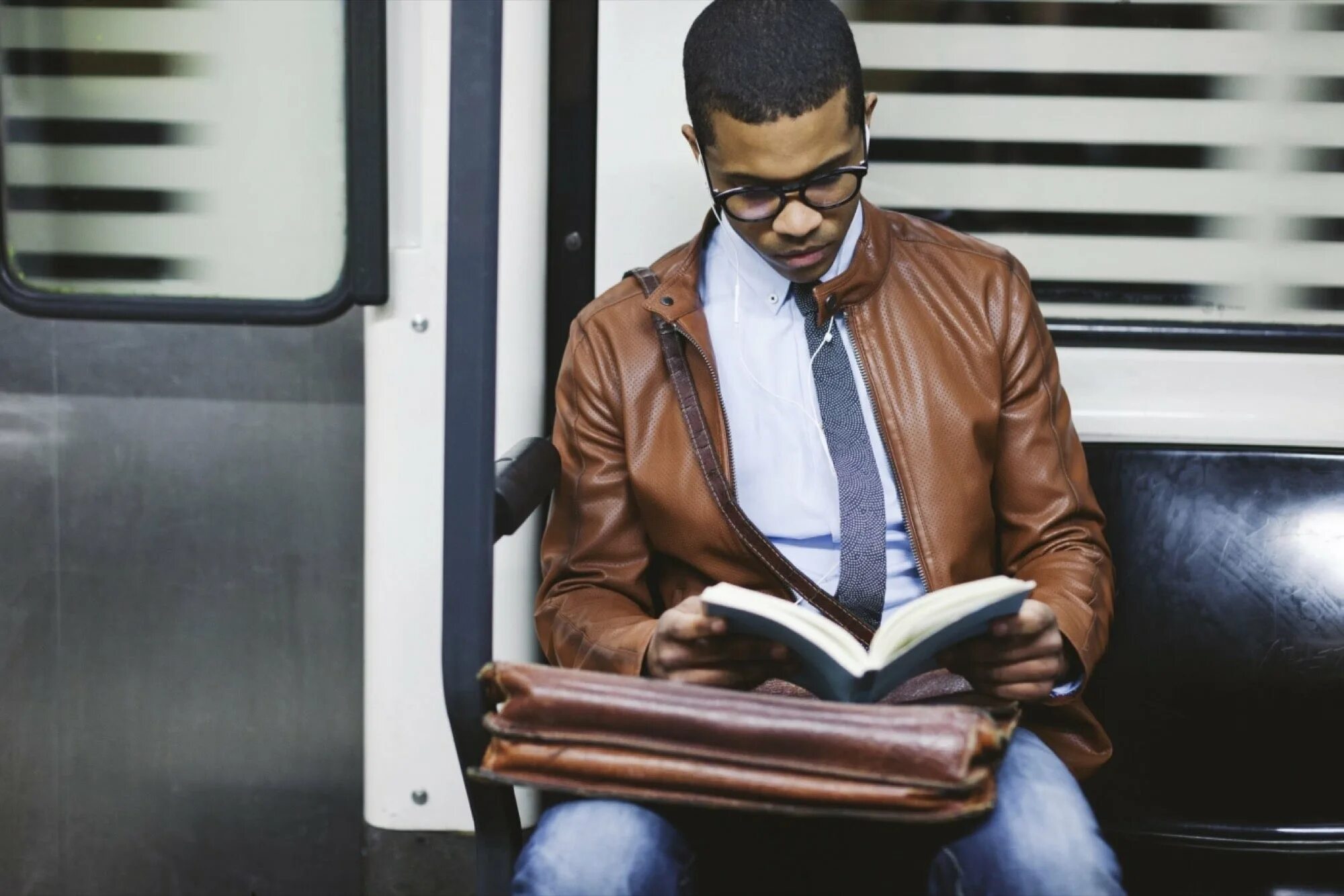 Are you reading a book. Reading. man reading book. reading on a coach. a person who is reading a book.