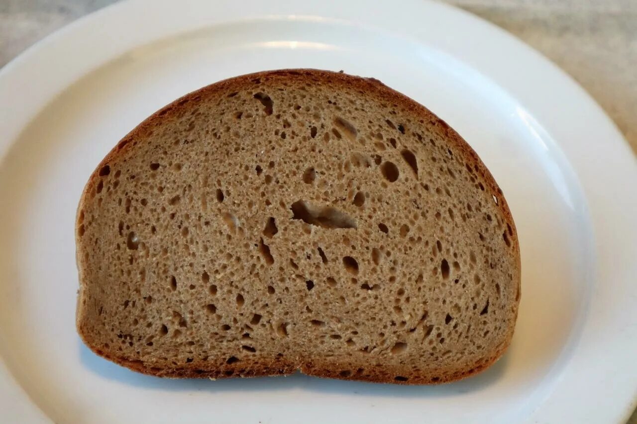 Черный хлеб Хатманово. Темный хлеб. Ломтик черного хлеба. Срез хлеба. Черных хлеб